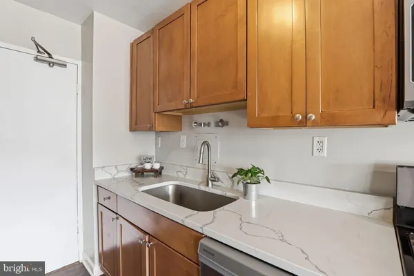 a kitchen with stainless steel appliances a sink a refrigerator and cabinets