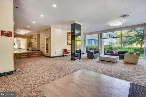a living room with couch and a floor to ceiling window
