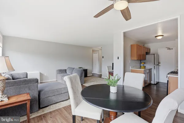 a dining room with furniture and wooden floor