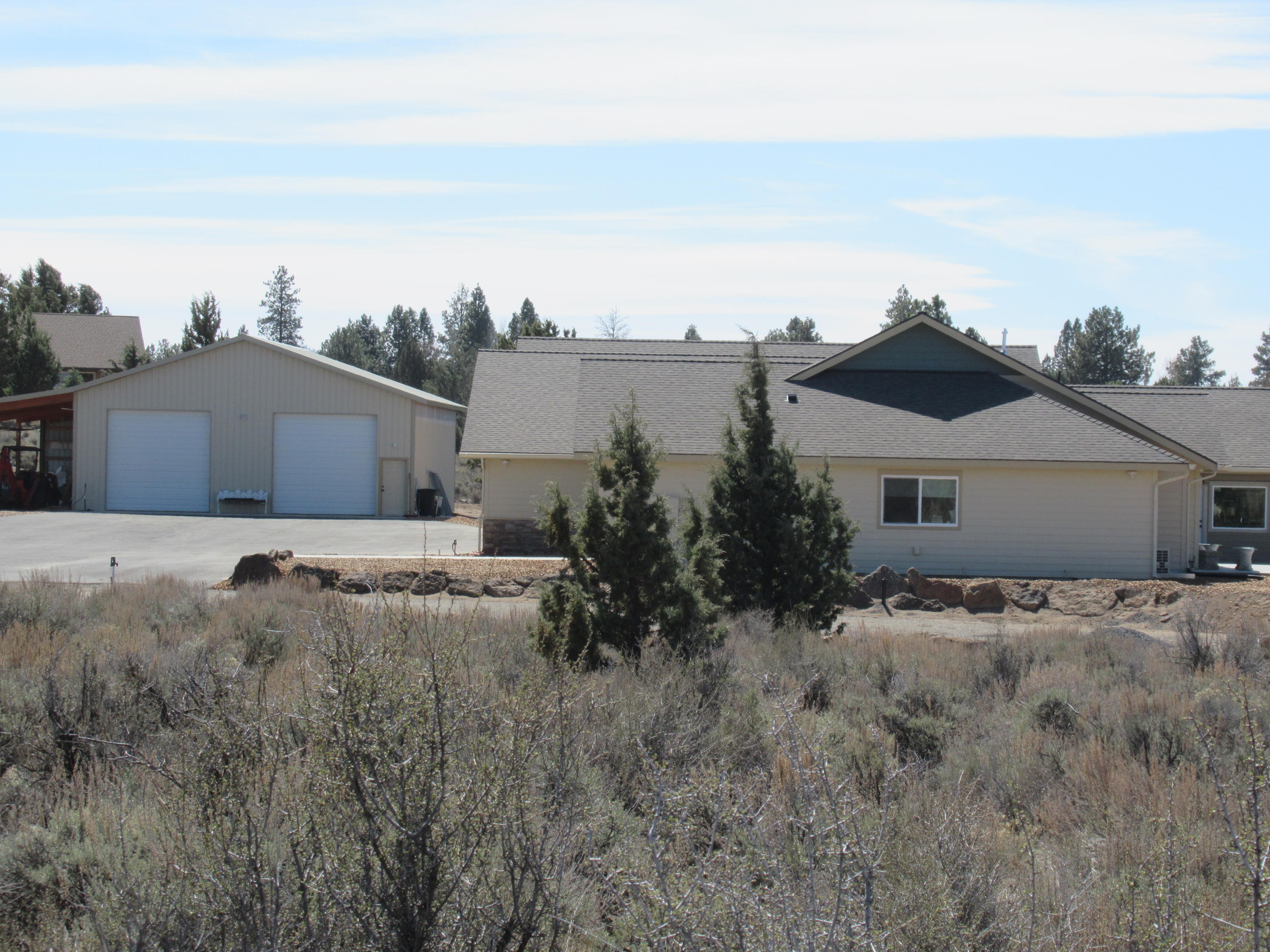 22063 Rickard Road Bend, OR 97702 - Photo 4 of 29 This view shows office window, and the 2000 ft. shop with carport at the end.
