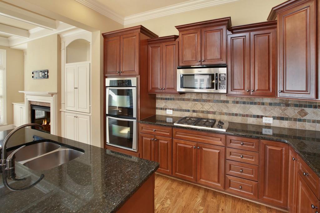 2010 Heathermere Way Roswell, GA 30075 - Photo 14 of 42 a kitchen with stainless steel appliances granite countertop a refrigerator a stove and a sink with wooden cabinets