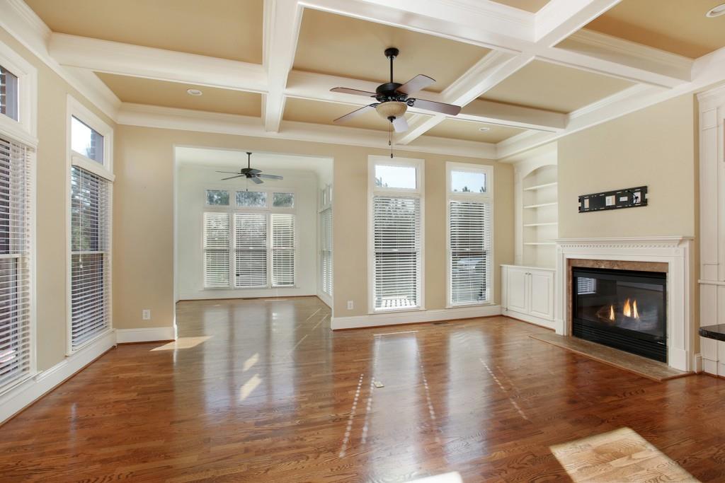 2010 Heathermere Way Roswell, GA 30075 - Photo 19 of 42 a view of an empty room with wooden floor and a fireplace