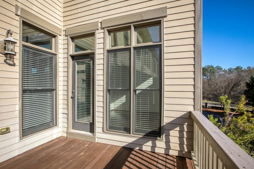 2010 Heathermere Way Roswell, GA 30075 - Photo 20 of 42 a view of a balcony with a floor to ceiling window and wooden fence