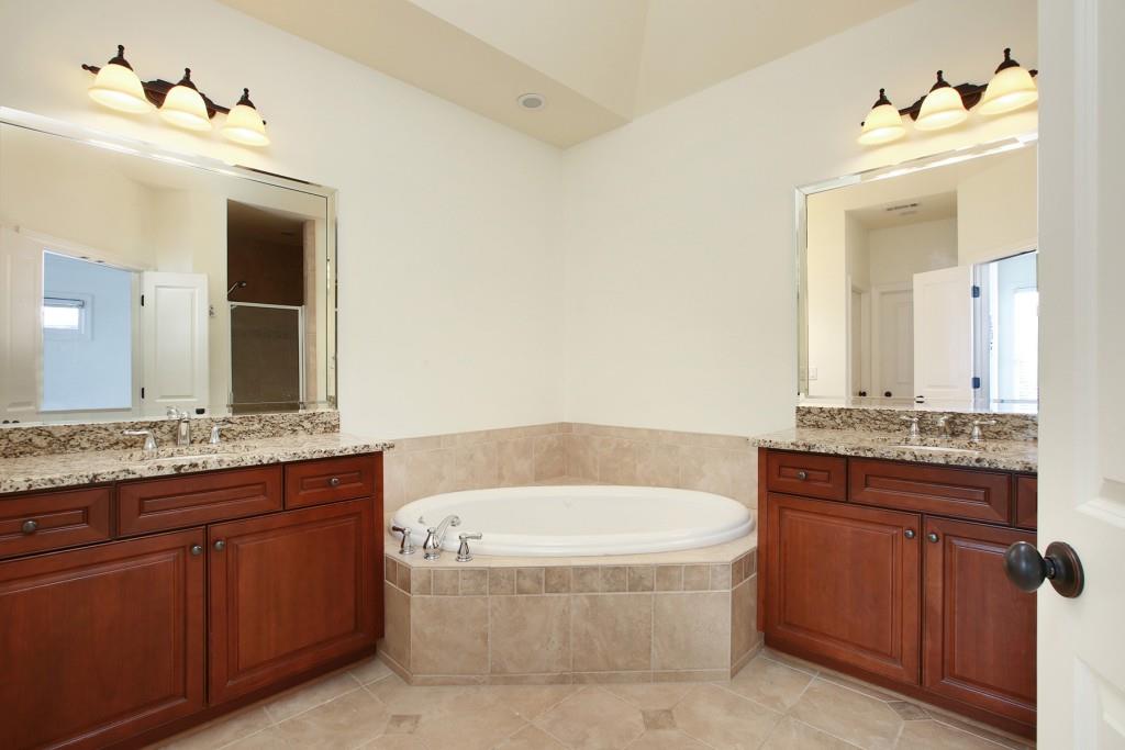 2010 Heathermere Way Roswell, GA 30075 - Photo 31 of 42 a bathroom with a tub a sink and mirror