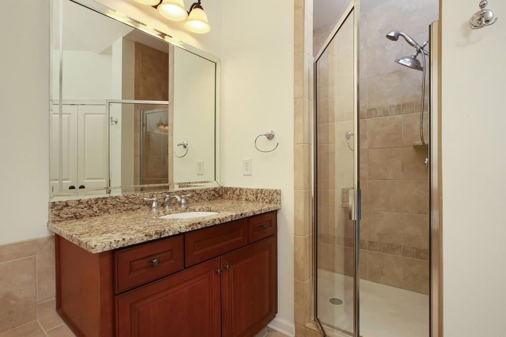 2010 Heathermere Way Roswell, GA 30075 - Photo 32 of 42 a bathroom with a granite countertop sink two mirror and shower