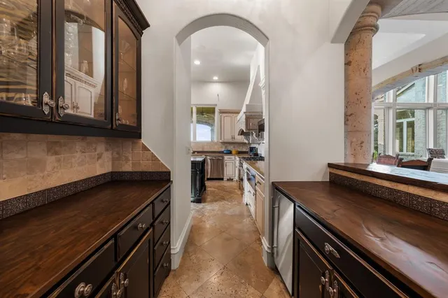a view of a kitchen with kitchen island a counter space a sink and a stove