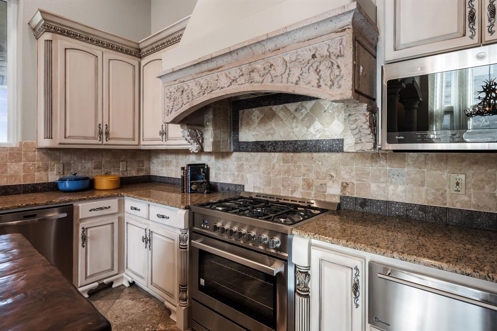 401 Brooks Hollow Road Lakeway, TX 78734 - Photo 13 of 40 a kitchen with stainless steel appliances granite countertop a stove and a microwave