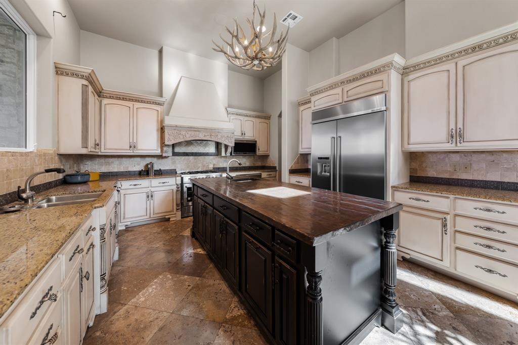 401 Brooks Hollow Road Lakeway, TX 78734 - Photo 14 of 40 a kitchen with stainless steel appliances granite countertop a sink a stove and a refrigerator