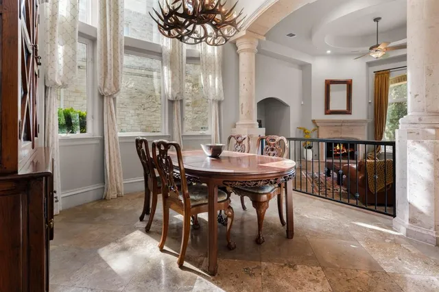 a view of a dining room with furniture and a chandelier
