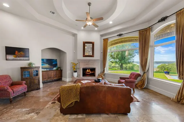 a living room with furniture a fireplace and a large window