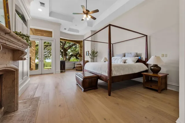 a bedroom with a bed couch and a chandelier