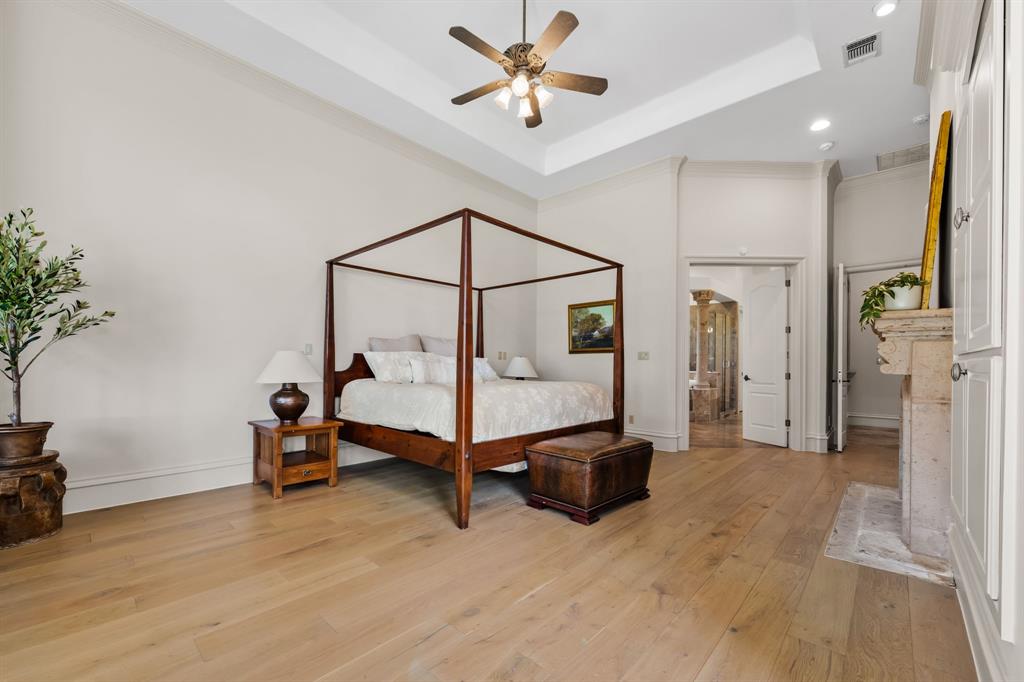 401 Brooks Hollow Road Lakeway, TX 78734 - Photo 21 of 40 a bedroom with a bed and a chandelier