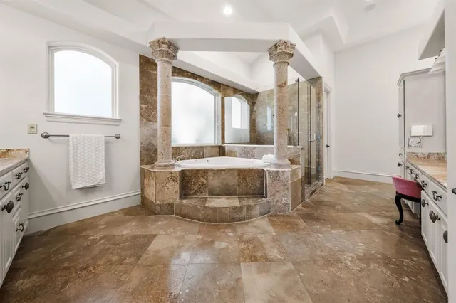 a bathroom with a tub sink and mirror