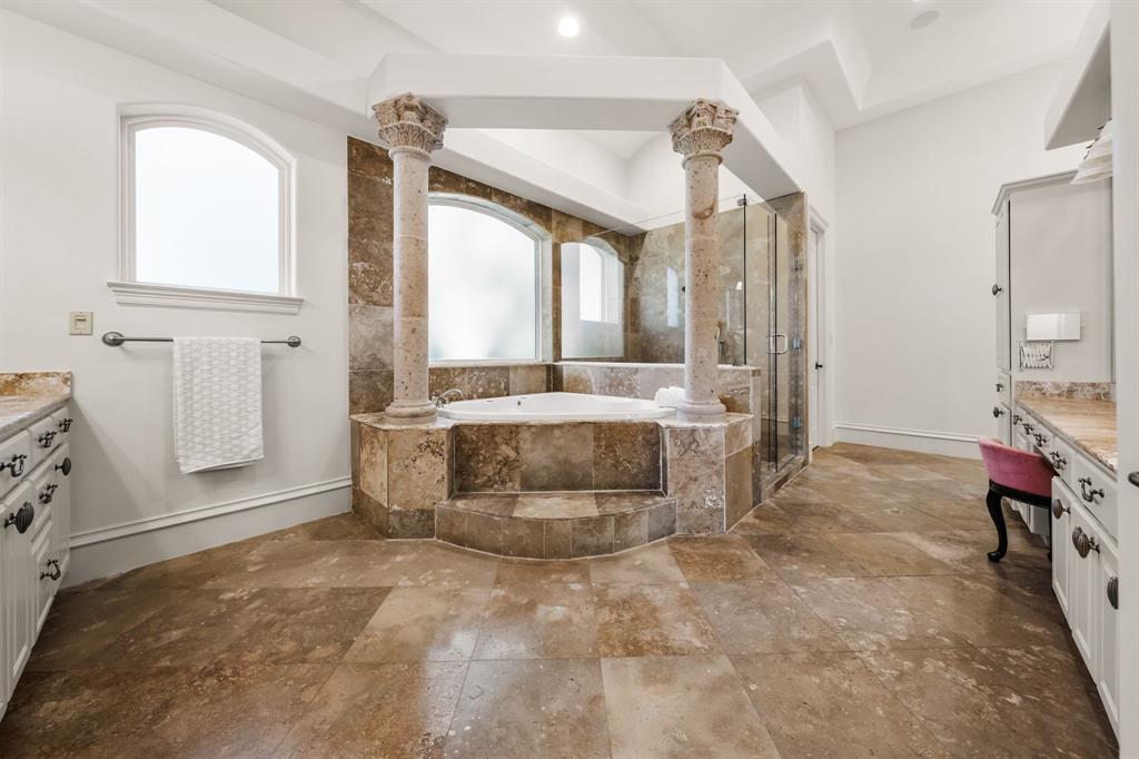 401 Brooks Hollow Road Lakeway, TX 78734 - Photo 22 of 40 a bathroom with a tub sink and mirror