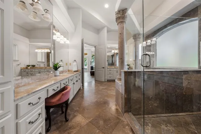 a bathroom with a granite countertop sink mirror and