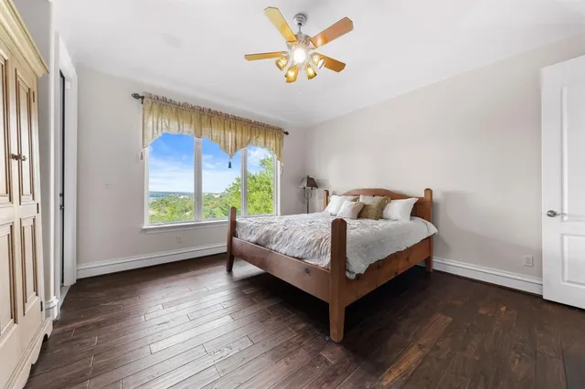 a bedroom with a bed and a large window