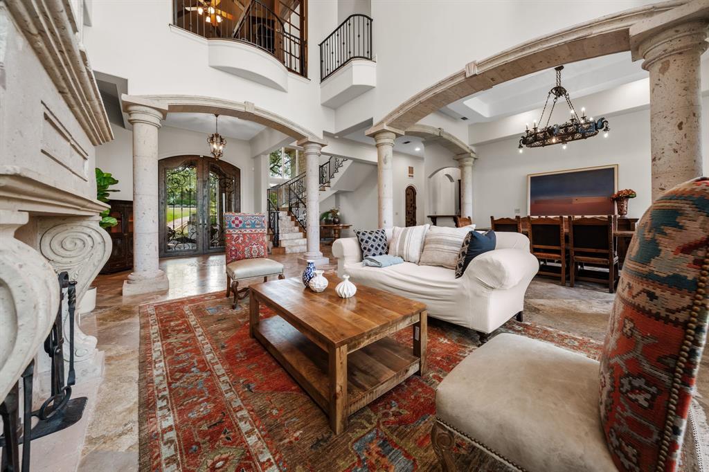 401 Brooks Hollow Road Lakeway, TX 78734 - Photo 3 of 40 a living room with furniture a fireplace and a chandelier