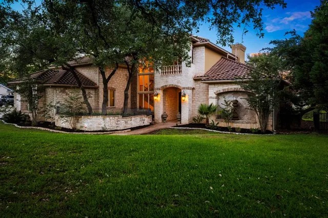 a view of a house with backyard and sitting area