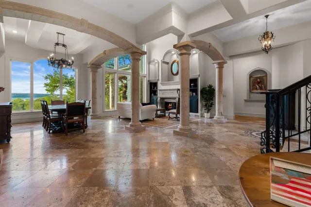 a living room with furniture a fireplace and a chandelier