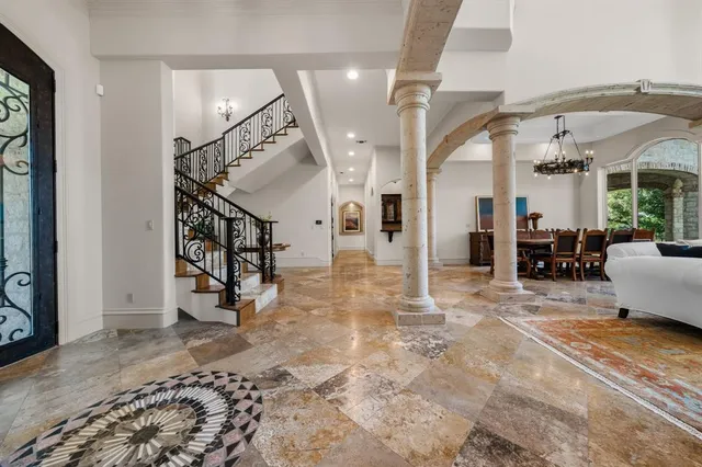 a view of a livingroom with furniture and a hallway