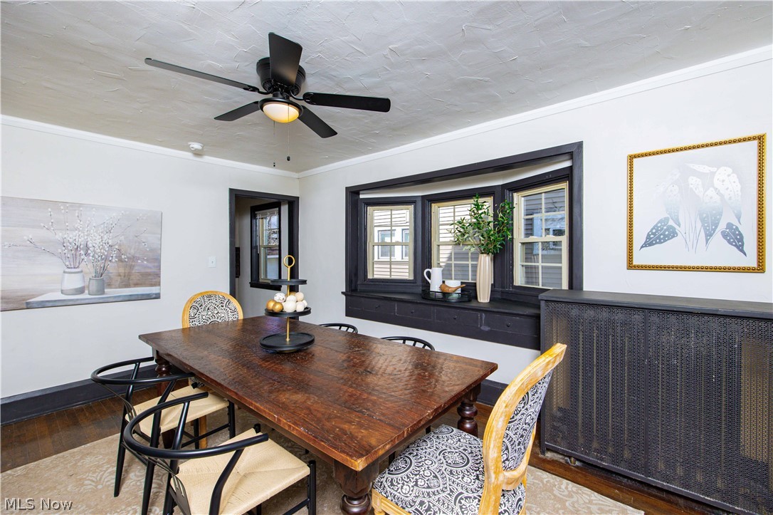 3254 Redwood Road Cleveland Heights, OH 44118 - Photo 11 of 49 Dining room with ornamental molding, ceiling fan, and wood-type flooring