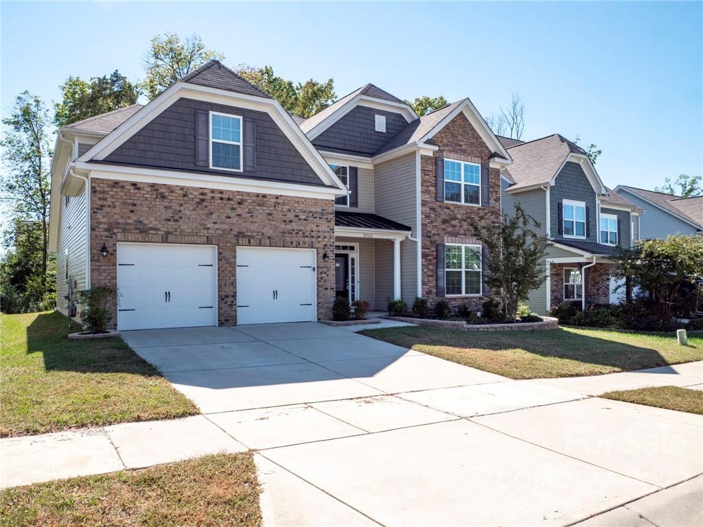 10502 Ebbets Road Charlotte, NC 28273 - Photo 1 of 48 a front view of a house with a yard and garage