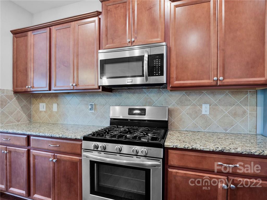 10502 Ebbets Road Charlotte, NC 28273 - Photo 11 of 48 a kitchen with granite countertop cabinets stainless steel appliances and a sink