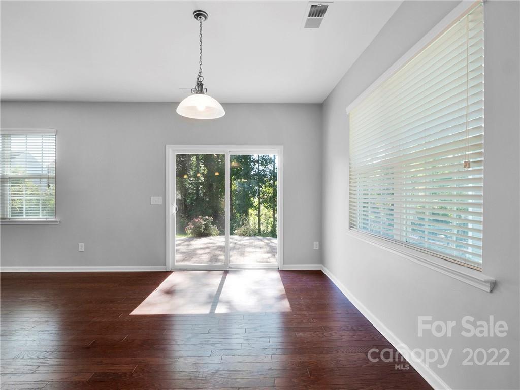 10502 Ebbets Road Charlotte, NC 28273 - Photo 14 of 48 a view of an empty room with wooden floor and a window