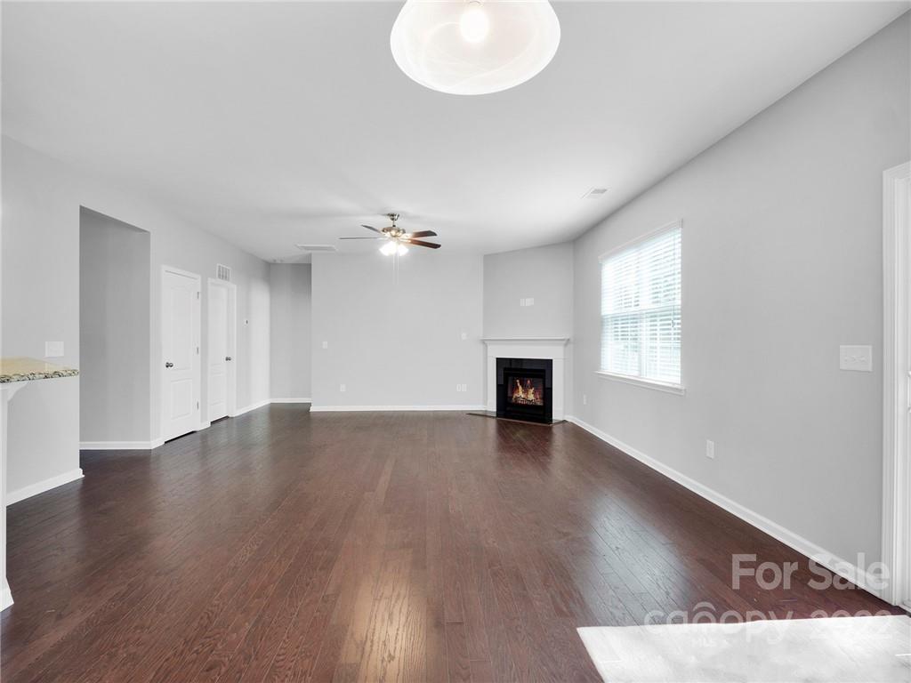 10502 Ebbets Road Charlotte, NC 28273 - Photo 15 of 48 an empty room with wooden floor and windows
