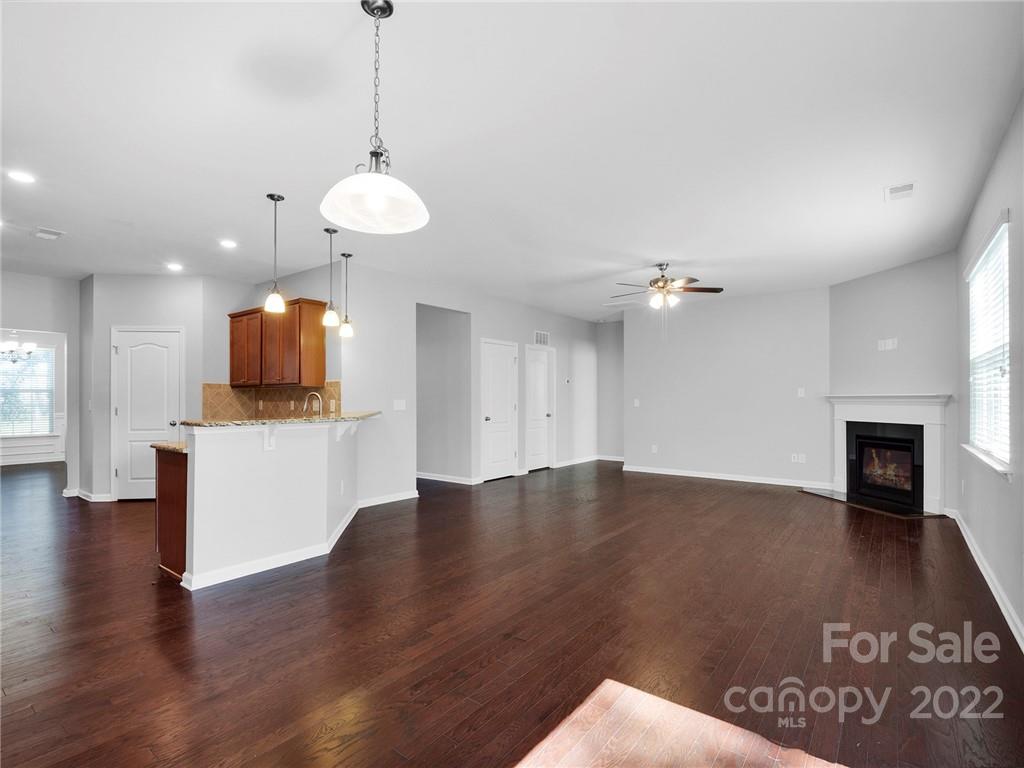 10502 Ebbets Road Charlotte, NC 28273 - Photo 16 of 48 wooden floor in an empty room with a fireplace