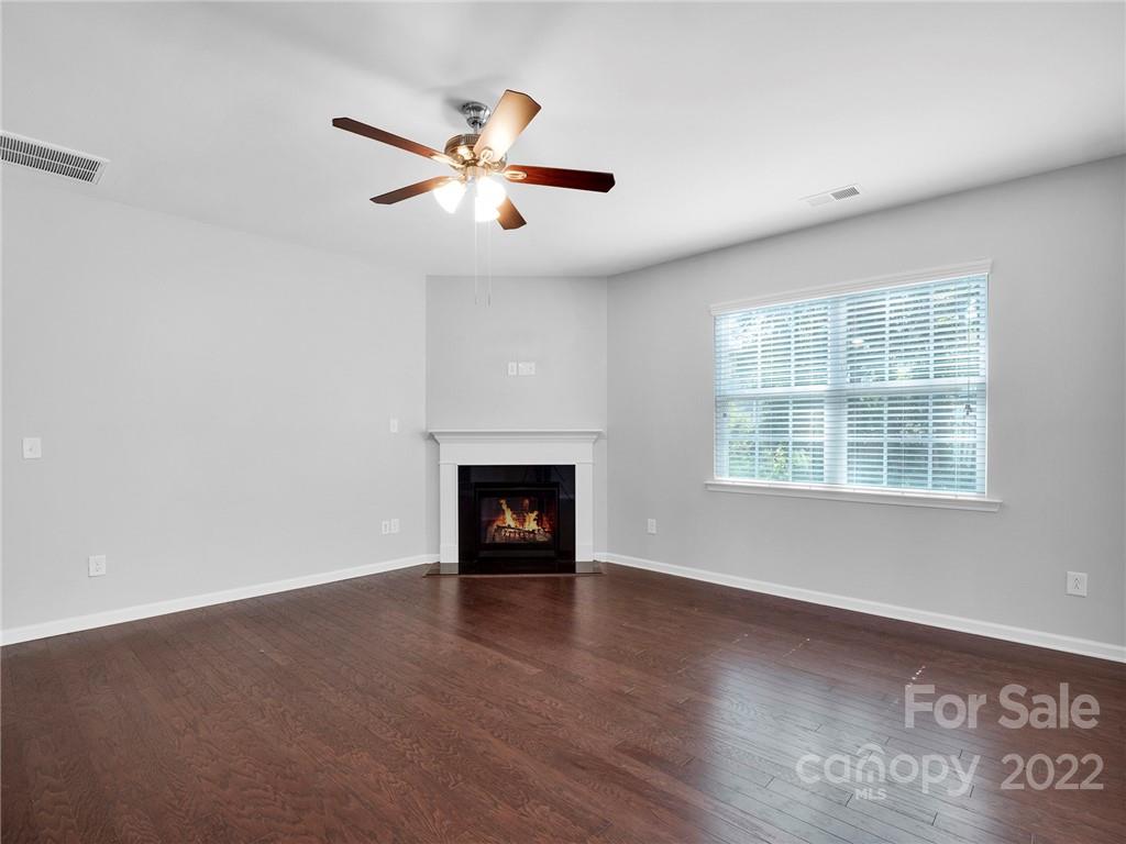 10502 Ebbets Road Charlotte, NC 28273 - Photo 19 of 48 an empty room with windows and fireplace