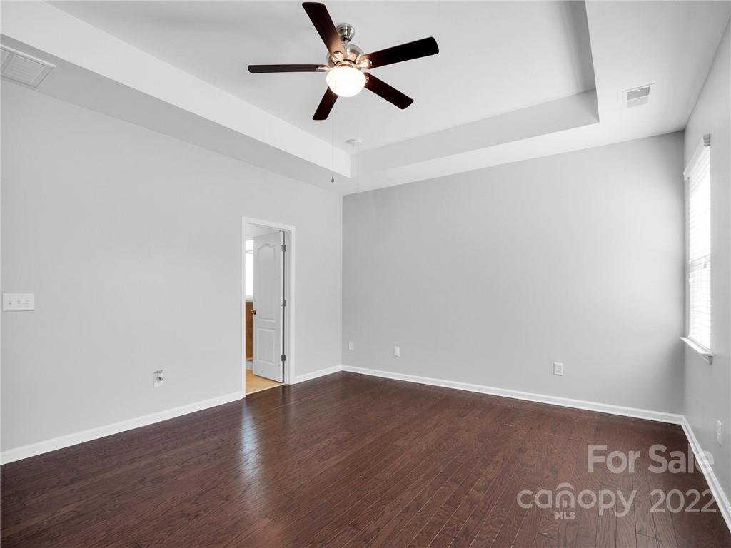 10502 Ebbets Road Charlotte, NC 28273 - Photo 24 of 48 an empty room with wooden floor and ceiling fan