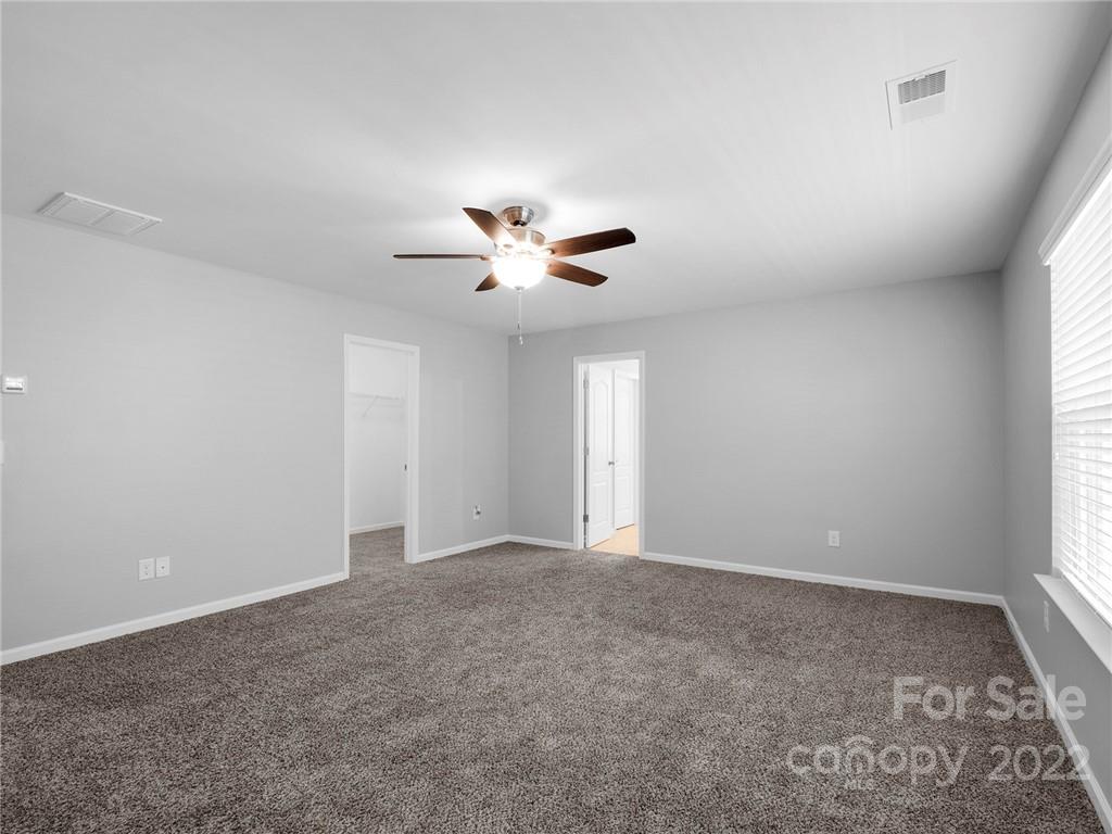 10502 Ebbets Road Charlotte, NC 28273 - Photo 27 of 48 an empty room with a window and a ceiling fan