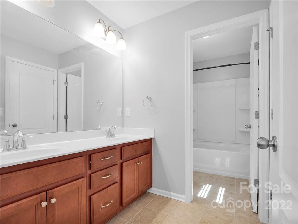 10502 Ebbets Road Charlotte, NC 28273 - Photo 36 of 48 a bathroom with a double vanity sink and mirror