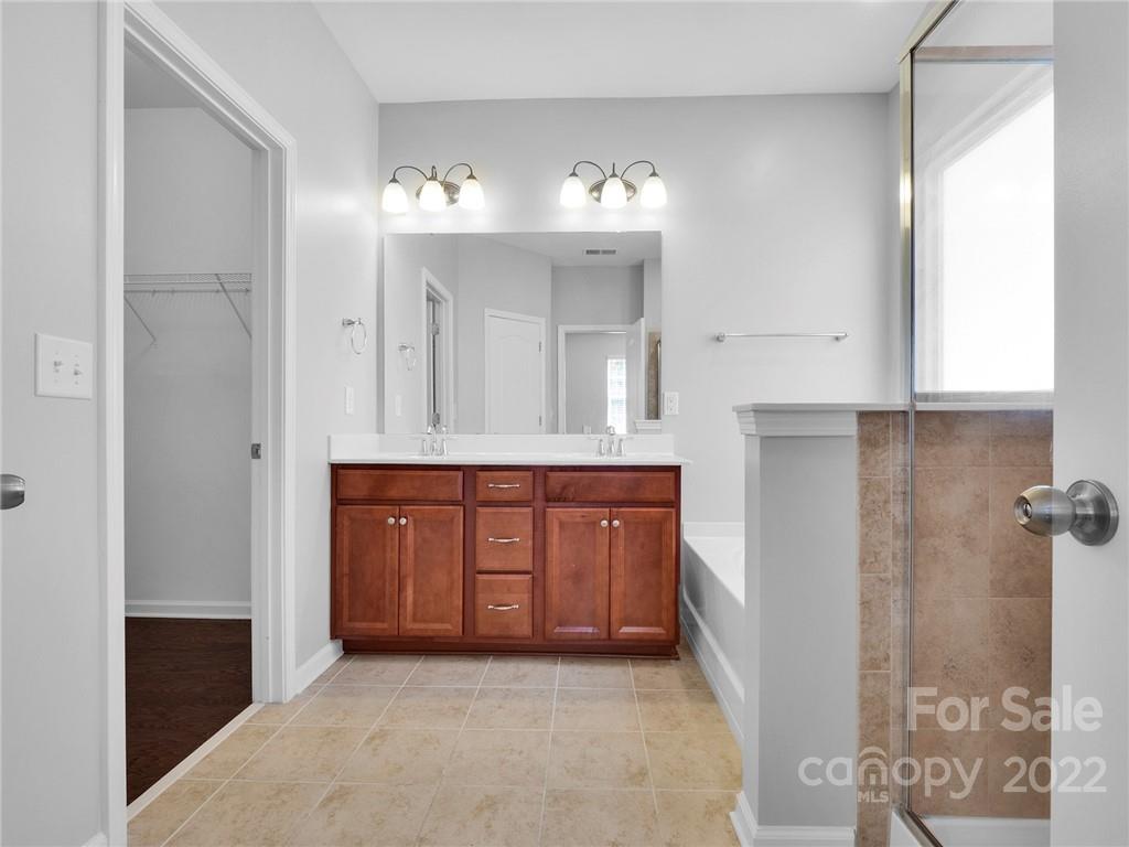 10502 Ebbets Road Charlotte, NC 28273 - Photo 41 of 48 a bathroom with a sink vanity and mirror
