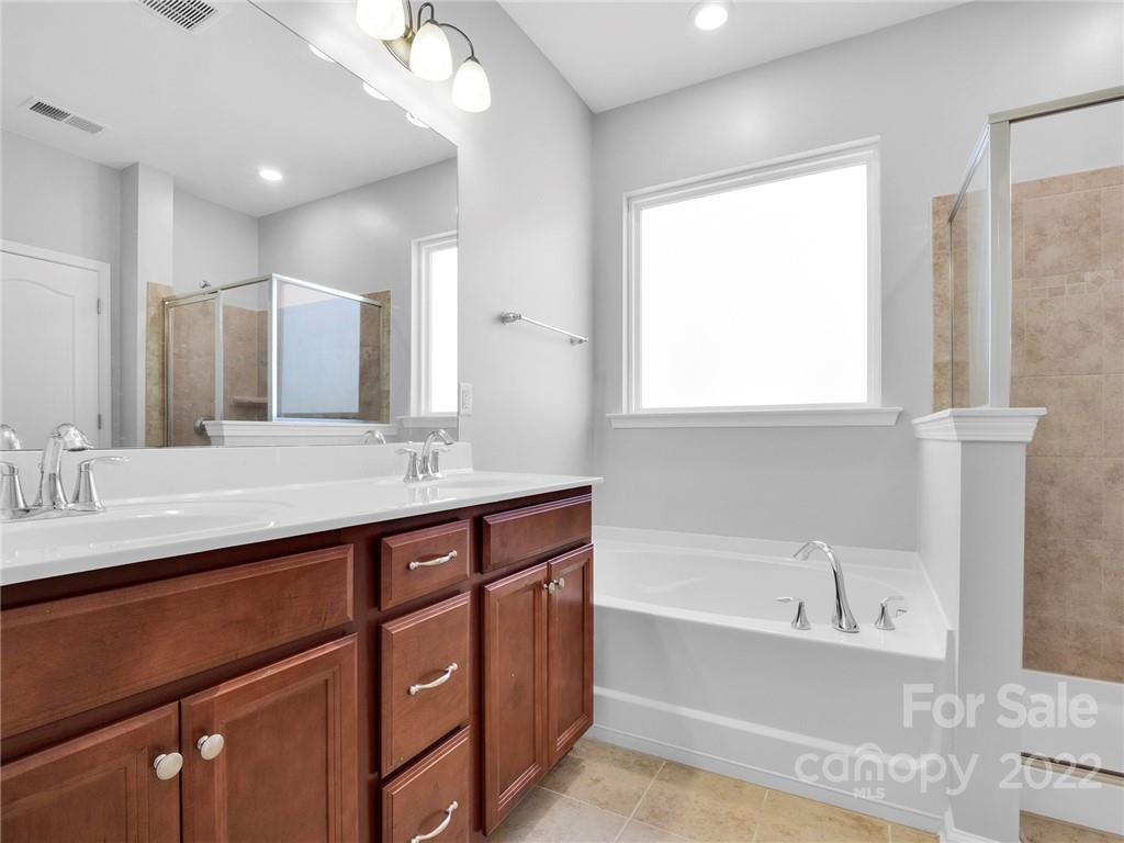 10502 Ebbets Road Charlotte, NC 28273 - Photo 42 of 48 a bathroom with a tub sink and mirror