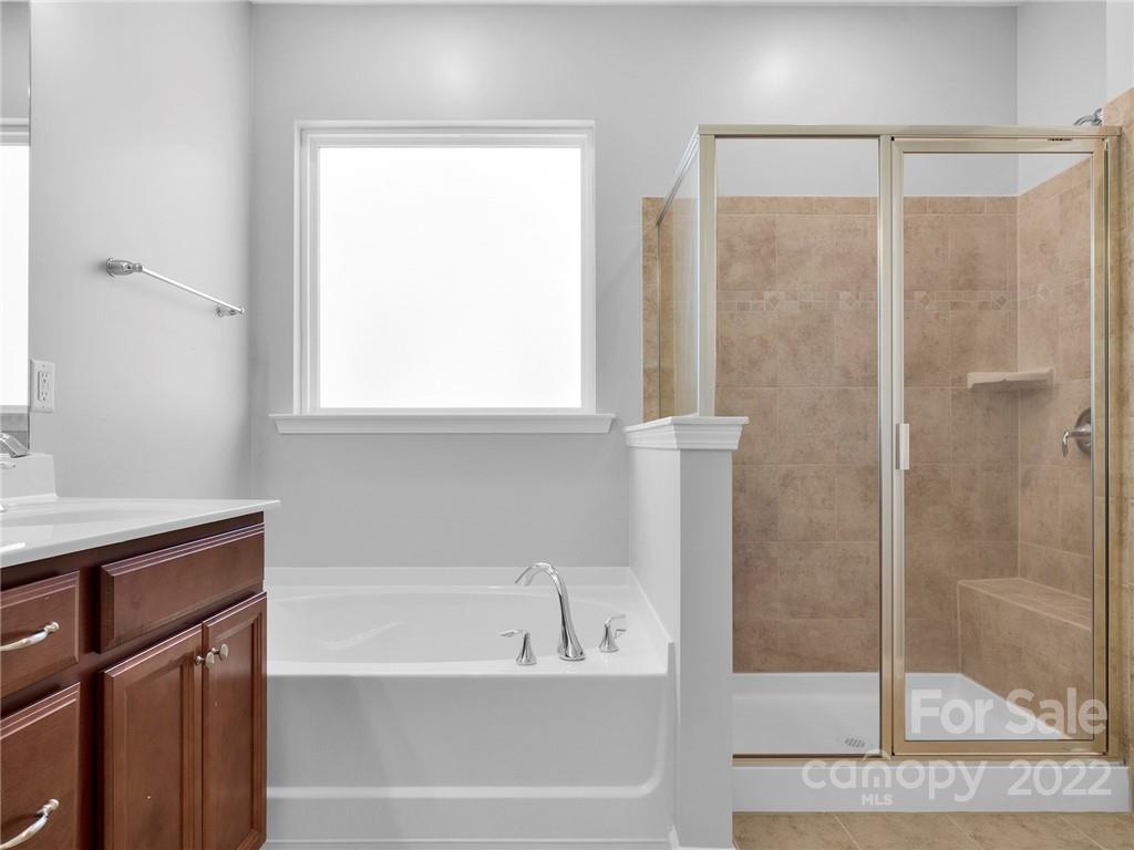10502 Ebbets Road Charlotte, NC 28273 - Photo 43 of 48 a bathroom with a bathtub and a shower