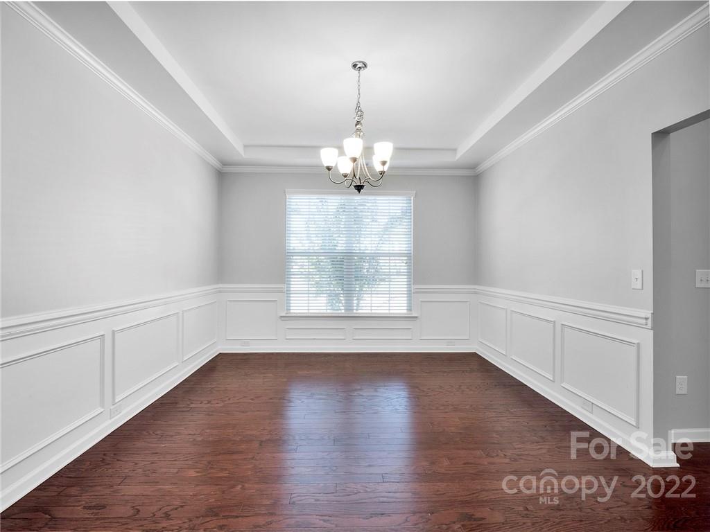 10502 Ebbets Road Charlotte, NC 28273 - Photo 5 of 48 an empty room with wooden floor and windows