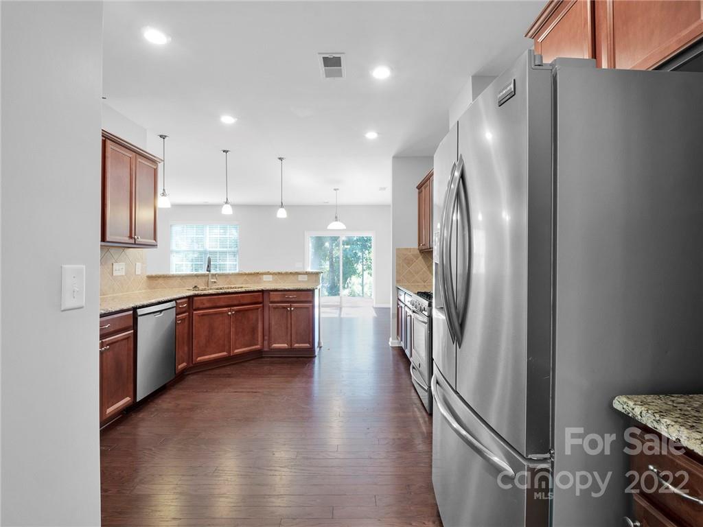 10502 Ebbets Road Charlotte, NC 28273 - Photo 8 of 48 a large kitchen with a large window and stainless steel appliances