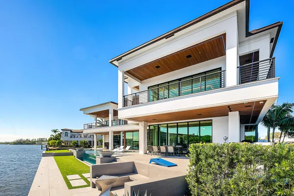 a view of a house with pool yard and a wooden deck