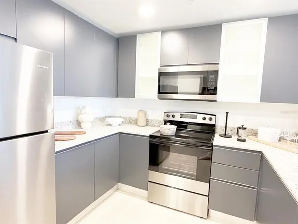 a kitchen with a sink stove and refrigerator