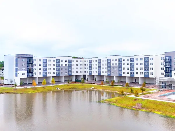 a large building with a swimming pool in front of it