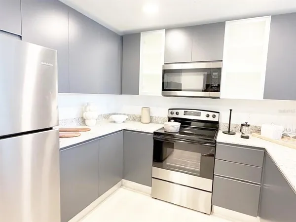 a kitchen with stainless steel appliances a refrigerator sink and microwave