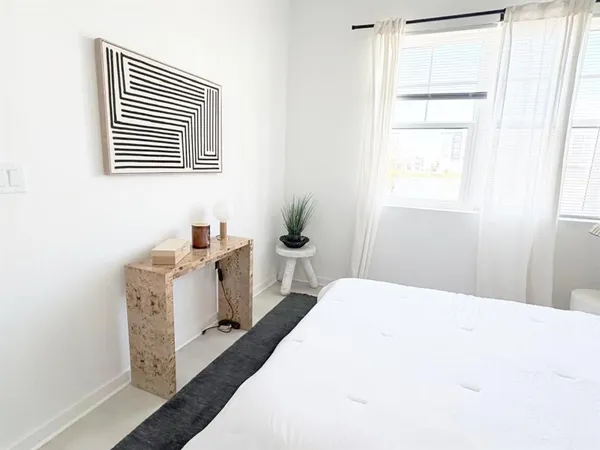 a bedroom with a bed and a window