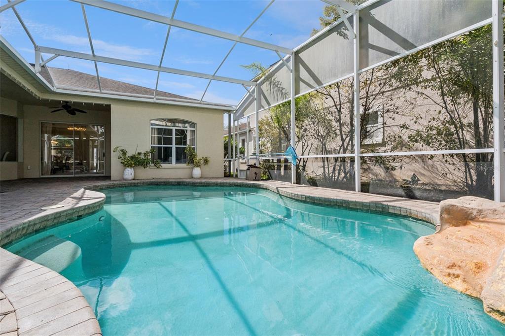 2541 Teton Stone Run Orlando, FL 32828 - Photo 52 of 82 a view of a backyard with table and chairs and wooden fence