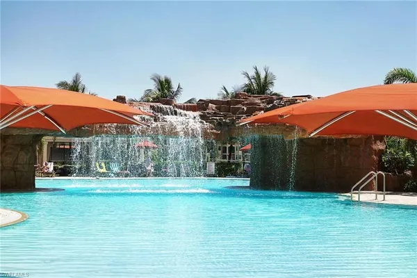 a view of a swimming pool with lounge chairs