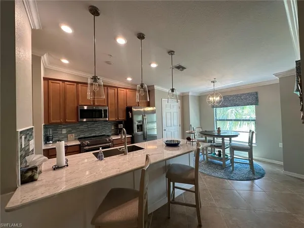 a large kitchen with a table and chairs