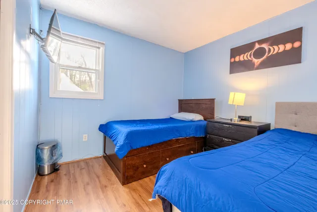 a bedroom with two beds and a window