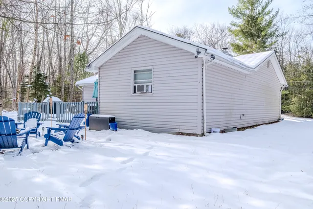 a view of a chair and table in backyard