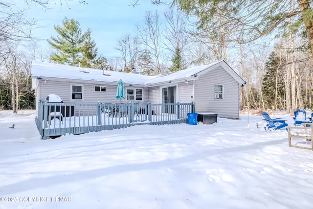 a view of a house with a patio and a yard